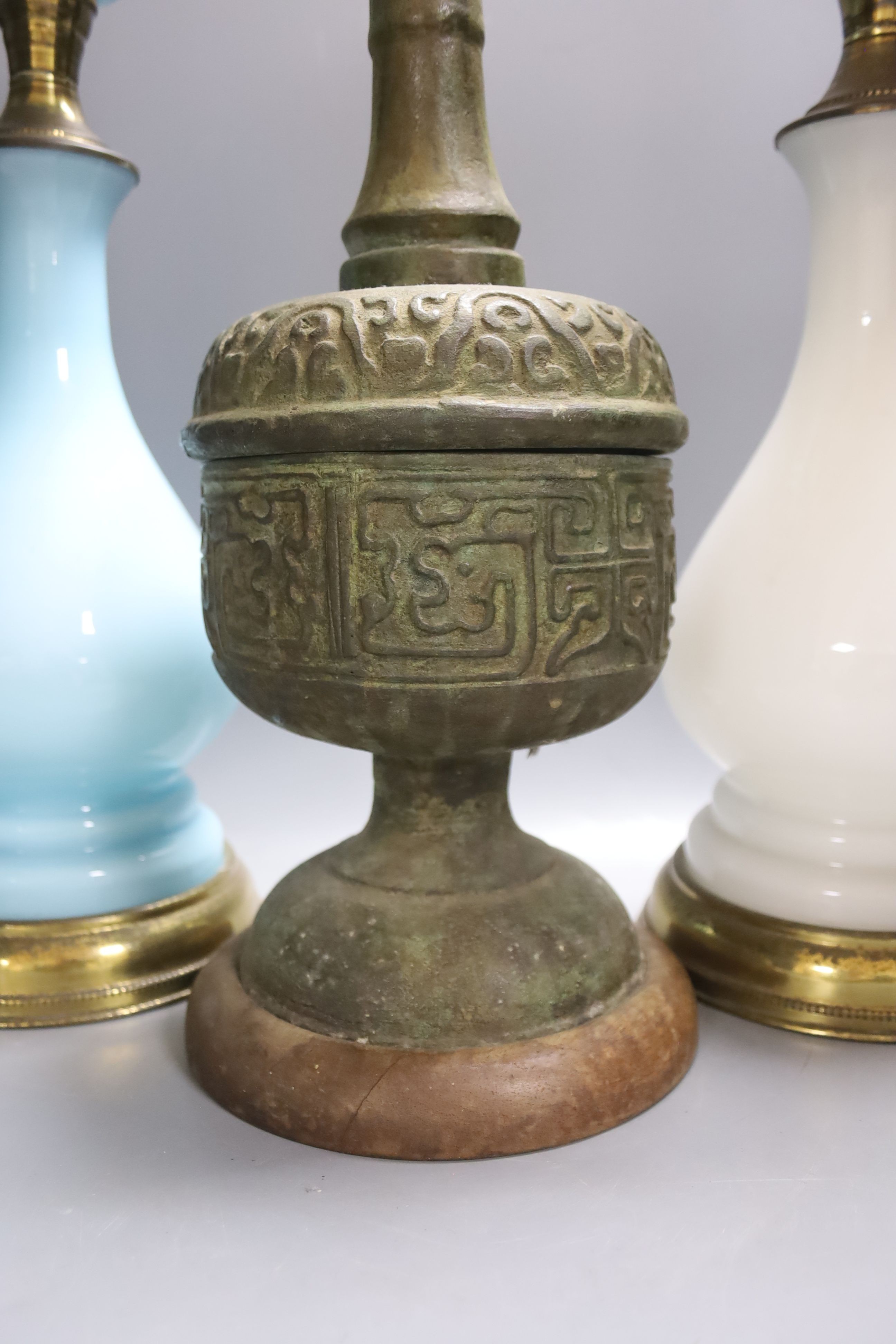 A pair of Victorian Opaline glass table lamps, 55cm high and archaistic brass table lamp